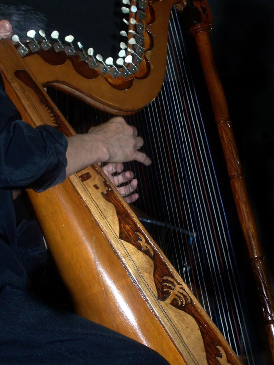 the man is playing on a large wooden instrument