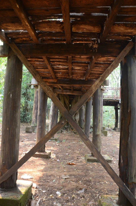 an old structure is constructed and stands in a field