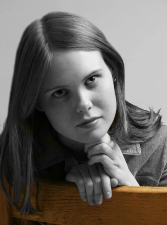 a close - up of a young lady holding her hand on her elbow