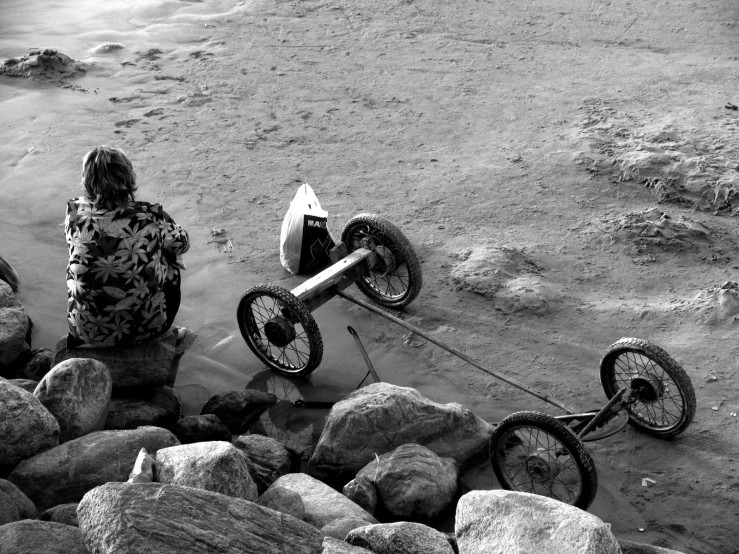 people sitting on rocks watching an extreme sports stunt