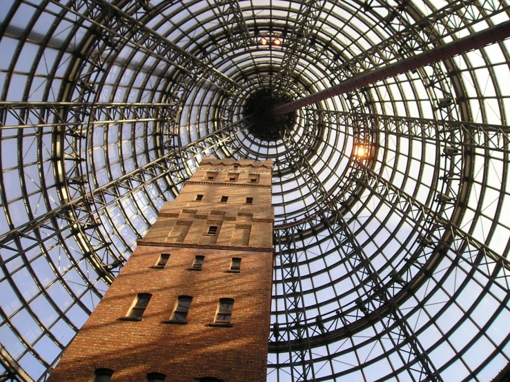 the inside of a huge, circular building has a tall structure with many windows