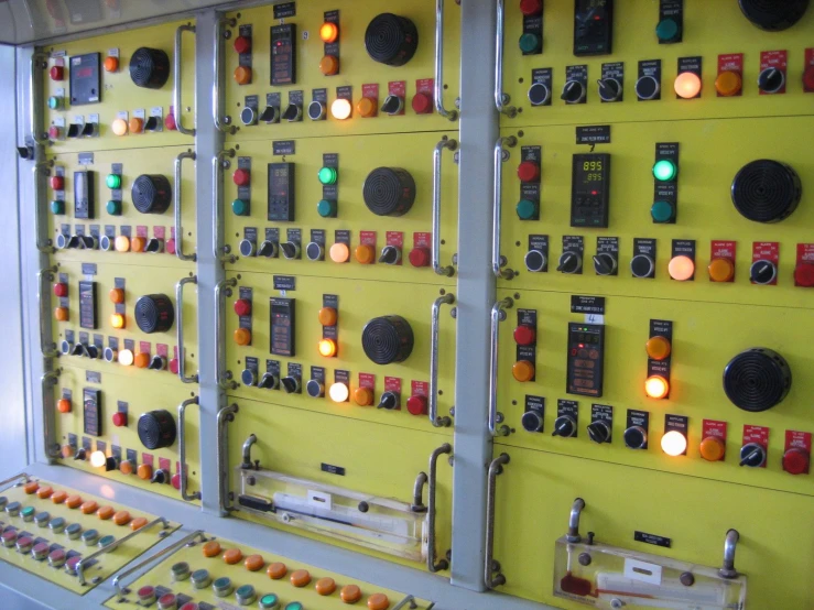 many controls are displayed on a yellow wall