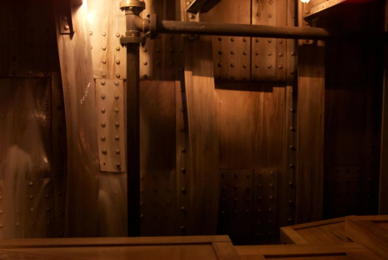 an industrial kitchen with shiny metal bars and a wood floor