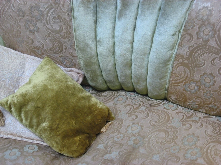a green cushion sitting on top of a couch