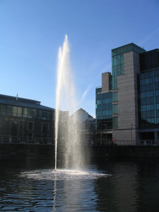 a fire hydrant spews water in a city pond