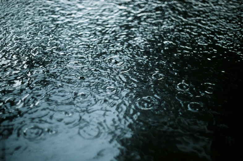 a large dark area covered in water and raindrops