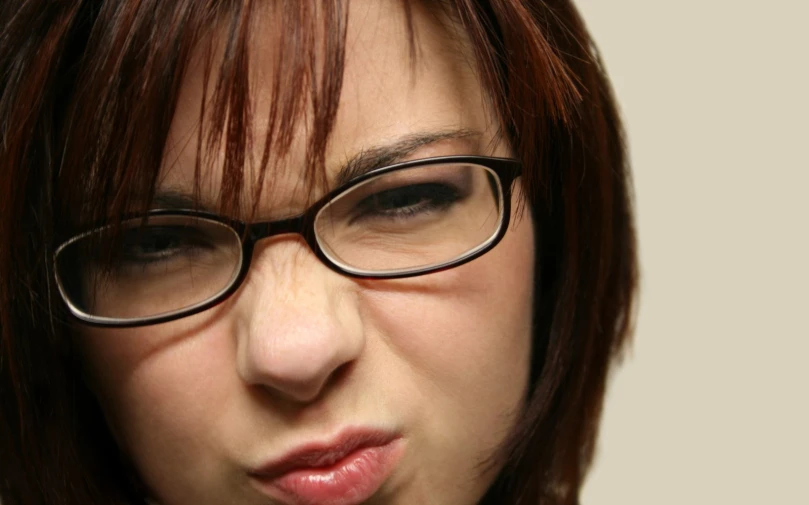 a girl with glasses making a surprised face