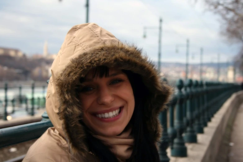 a woman standing near a railing in the winter