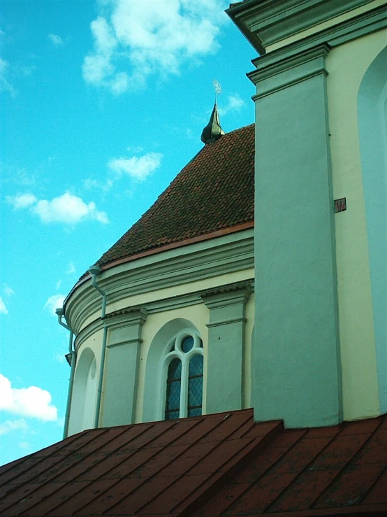 the roof of an old building with a clock tower in the distance