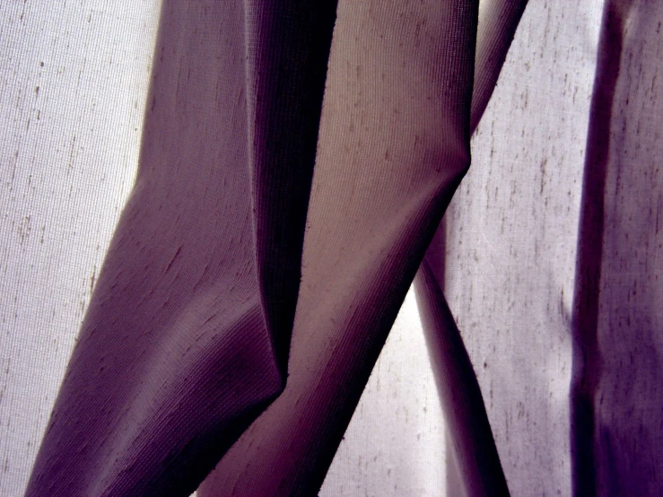 a pair of purple cloths that are hanging on a clothes line