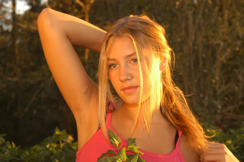 young woman in a pink tank top posing for a picture