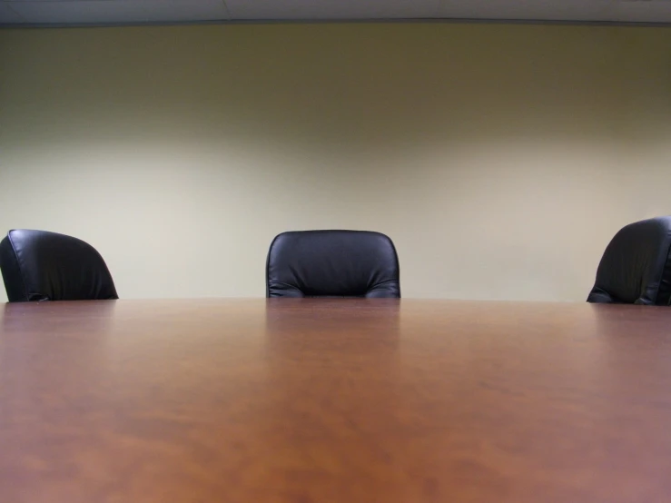 four chairs are sitting in front of a desk