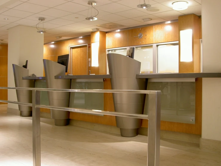 an office lobby has a large metal trashcan