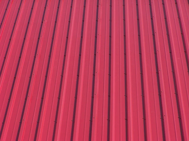 a red metal roof with an overcast sky