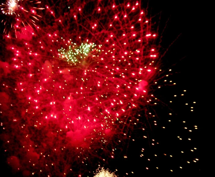 a bright red heart made from fireworks in the night sky