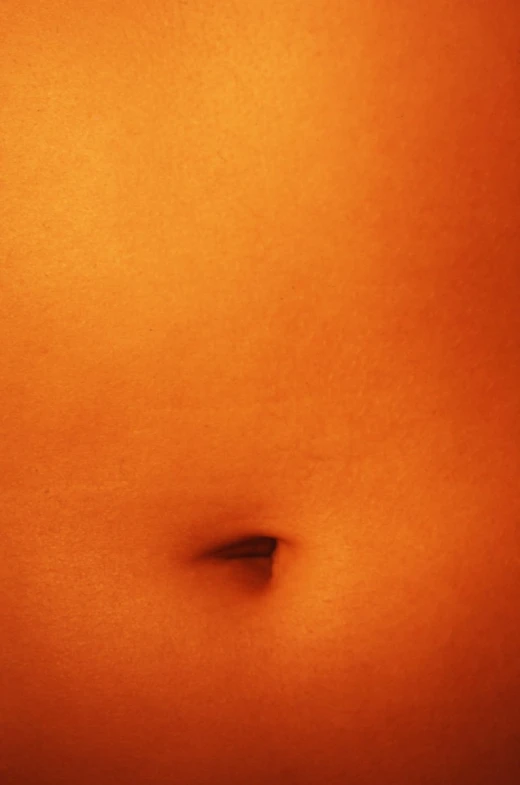 the womans stomach shows small brown spots on it