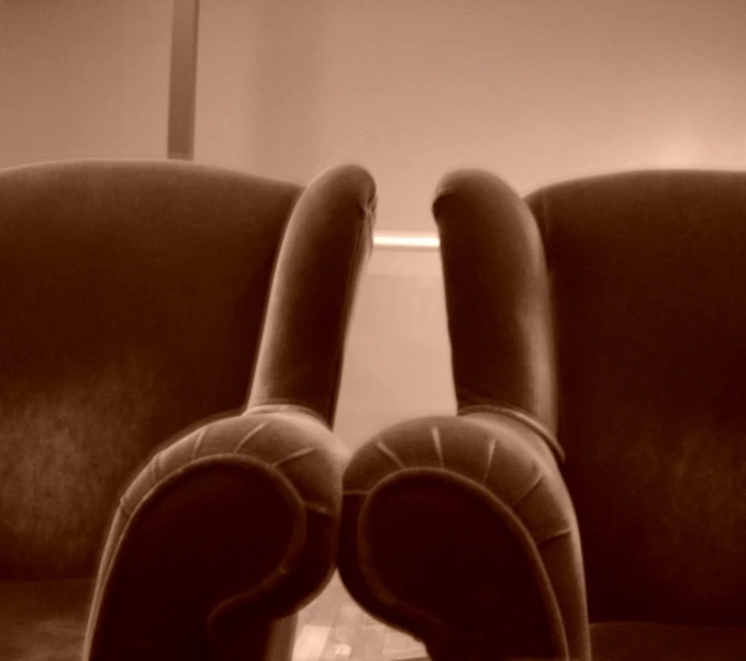 two chairs with slippers sitting on them in front of a mirror