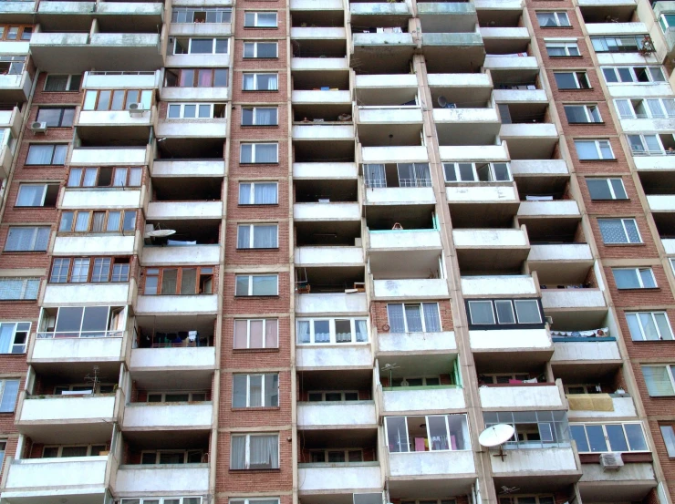 a very tall building with many balconies on the top