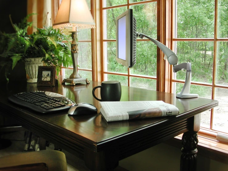 a view of a desk and window, with the computer on it