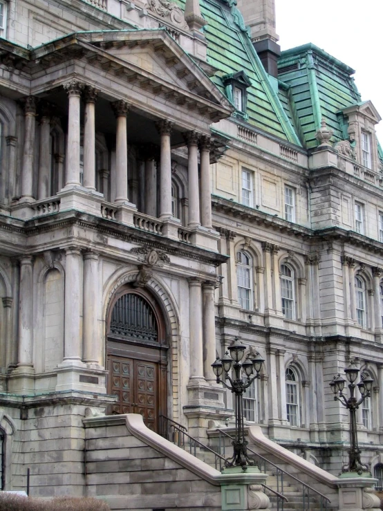 a huge building with ornate design around the doors