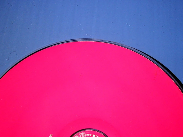 a red disk sitting on top of a blue table