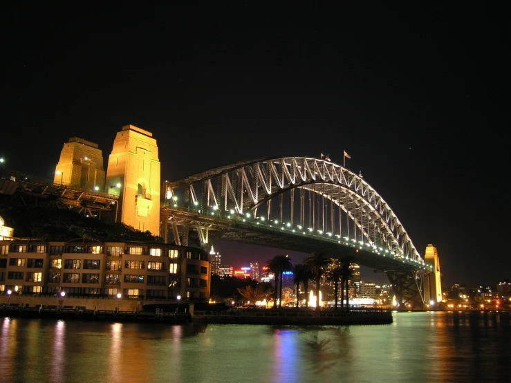 the sydney bridge over looking the water has a lot of lights
