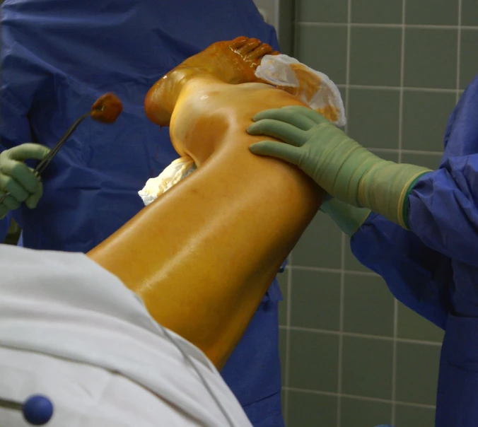 doctor hands holding a medical device to an individual's leg