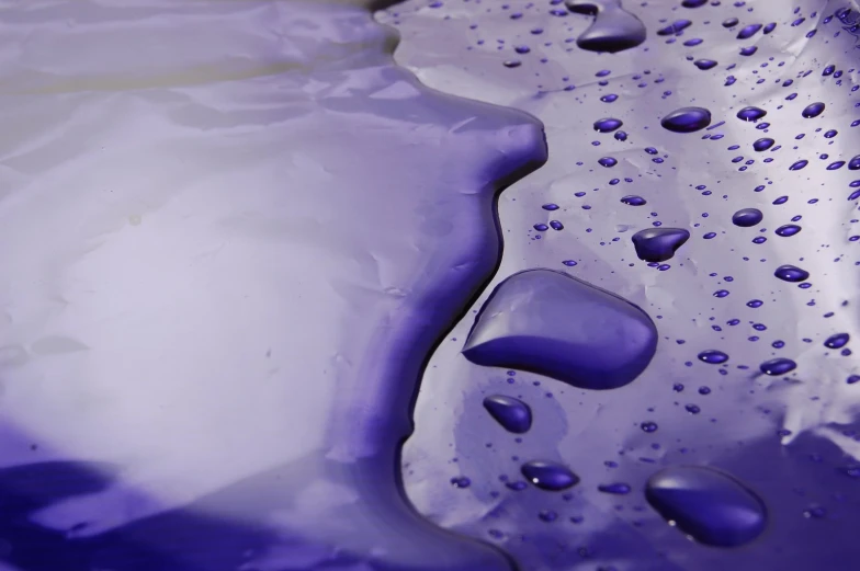 closeup s of water droplets on a purple material