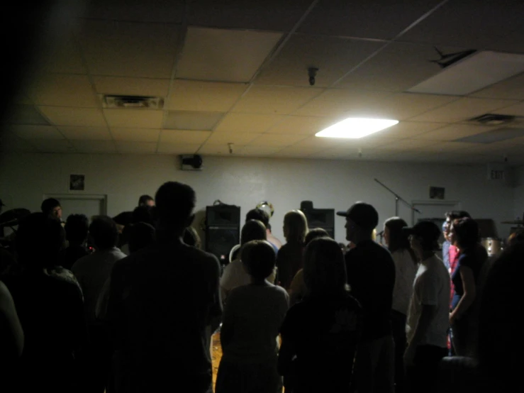 a group of people are standing inside a room