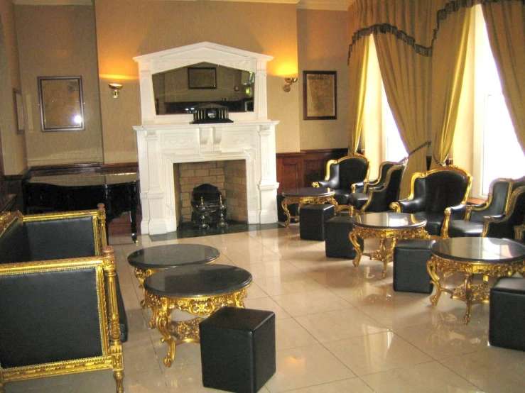 a set of five gold trimmed chairs in front of a fireplace