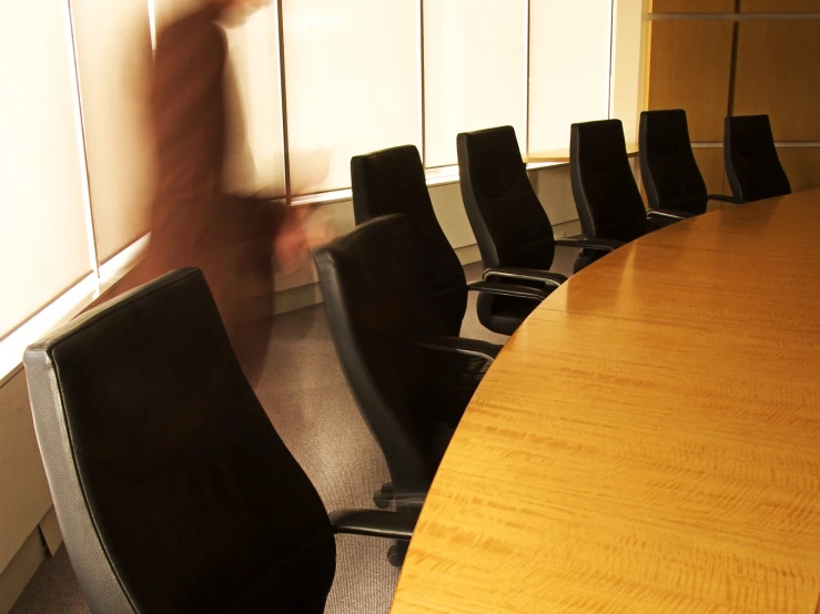 the long conference table is empty of people