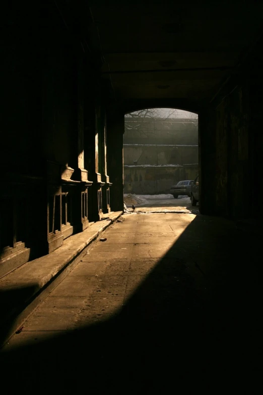 the shadows on the pavement are cast by the street lamp