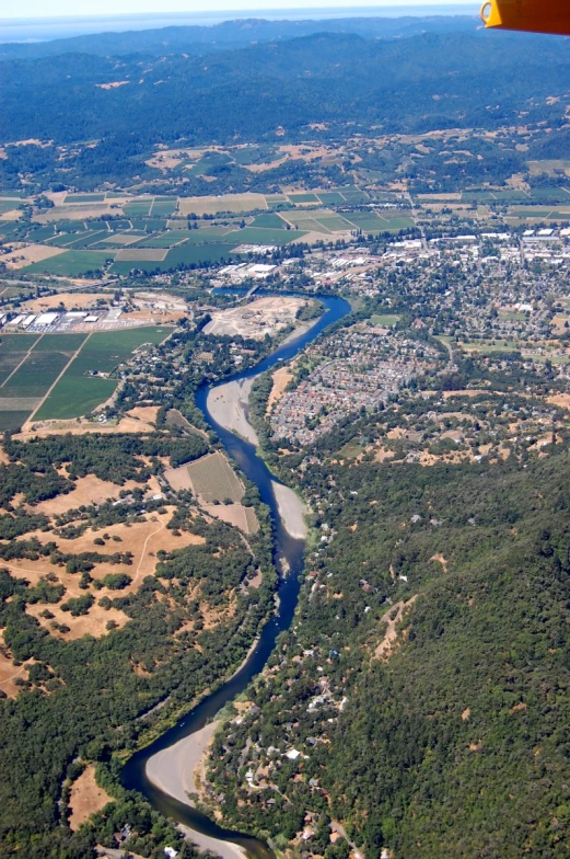 an aerial view of the small town and river