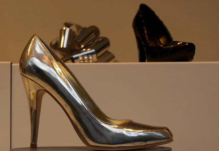 a close up of a gold high heel shoe