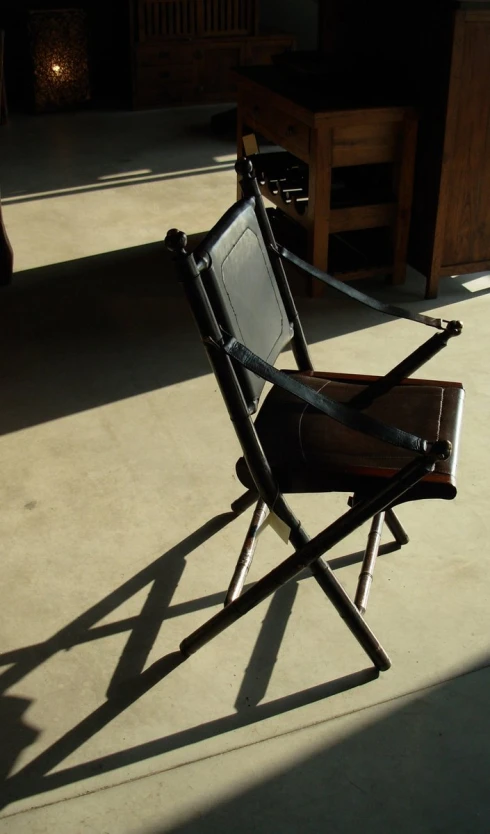 an old chair that has been taken out on a patio