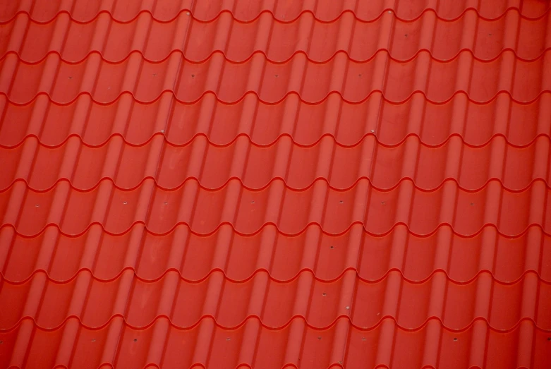 a red roof with the top of the tiles missing