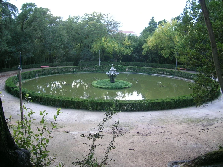 an old and dusty garden with a large fountain