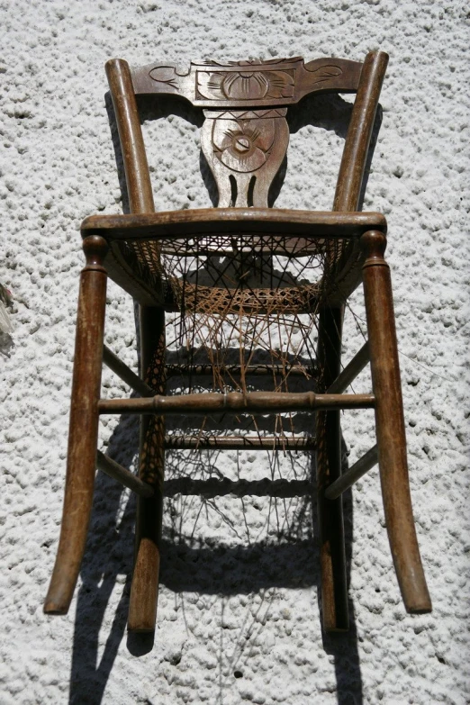 an old wooden rocking chair sitting on top of white sand