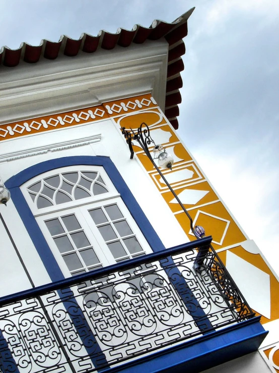 an ornate balcony railing on a white building