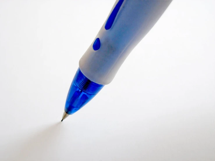 a blue and white pen resting on a table