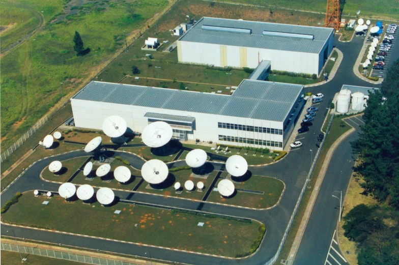 an aerial po showing several large white  spots on an industrial lot