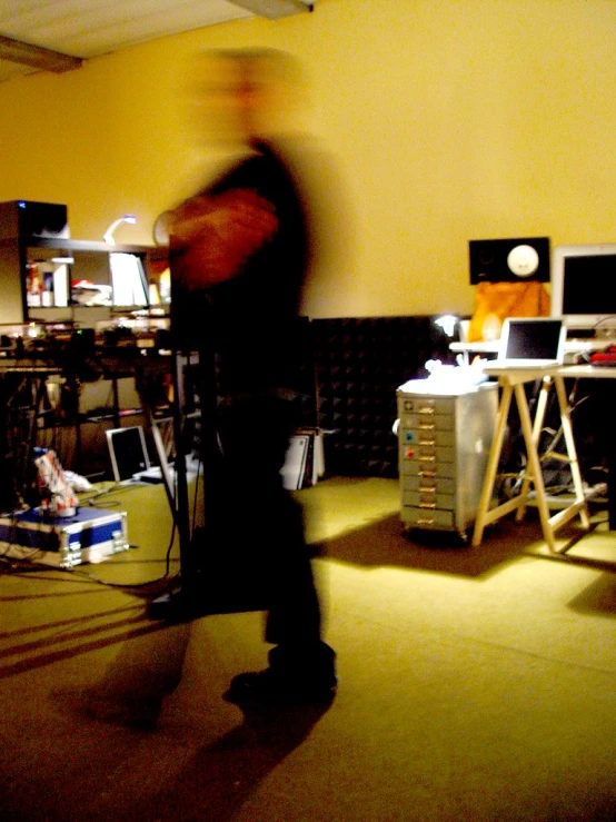 the man is standing in front of a computer equipment