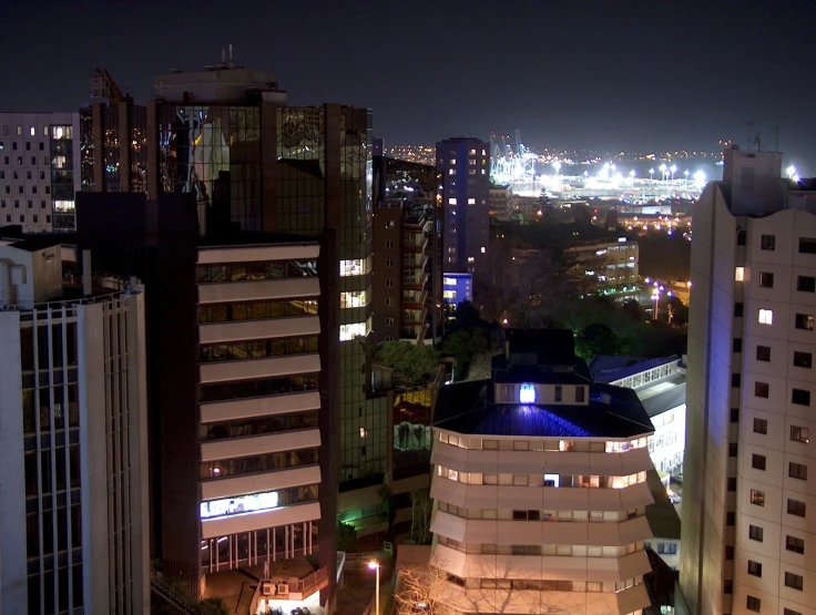 city at night with many buildings on both sides