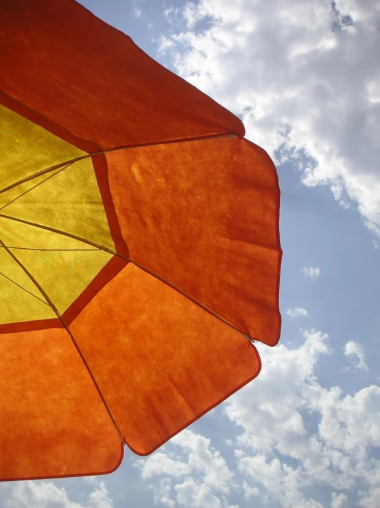 a close up view of an orange and yellow umbrella