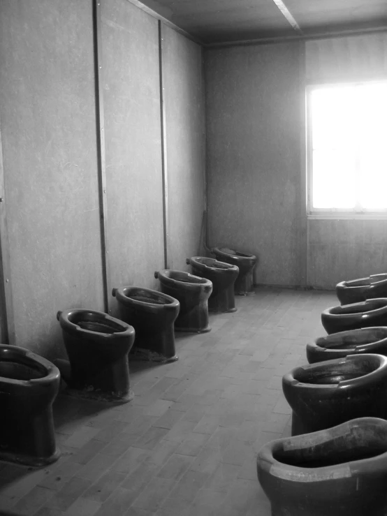 an old bathroom with many toilets in it