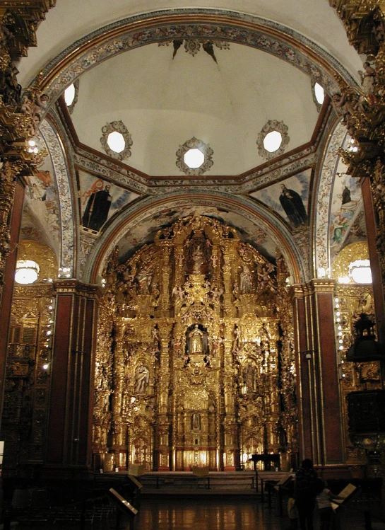 the interior of an elegant cathedral looking to the alter