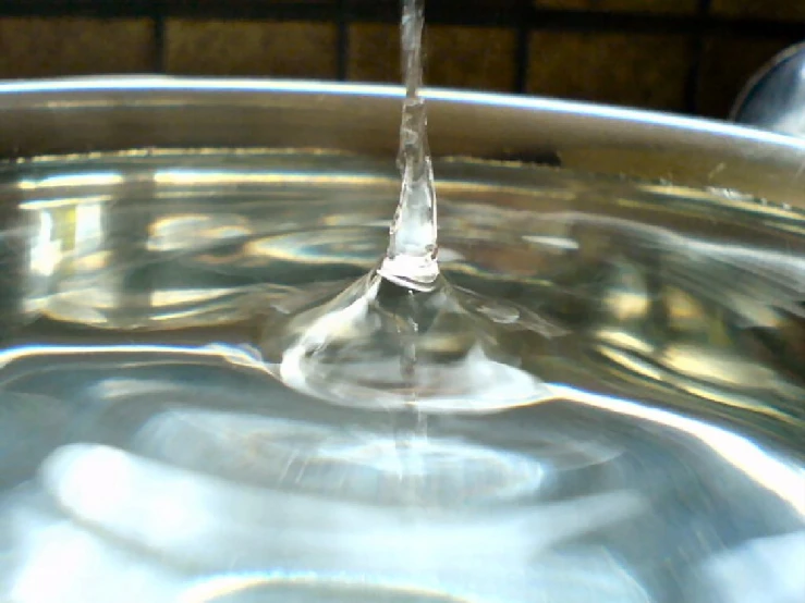 a faucet in the middle of a bowl of water