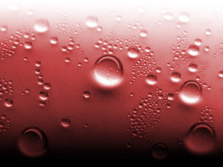 drops of water on red plastic material, with an abstract background