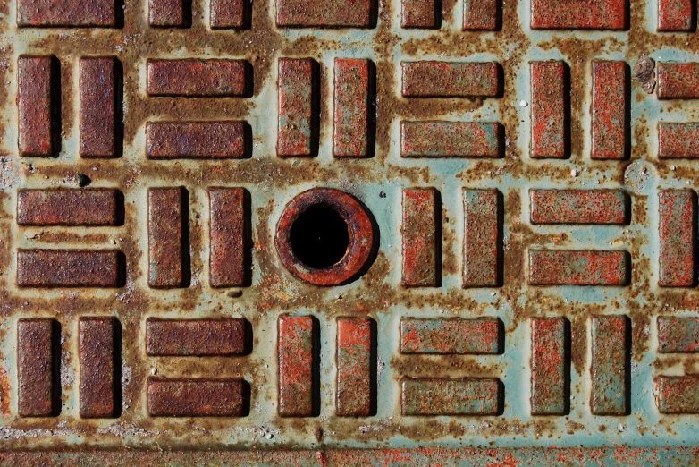 rusty looking manhole cover on an old sewer cover