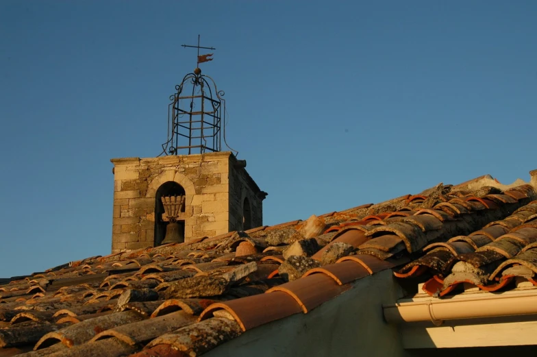 an old brick roof with a small bell tower